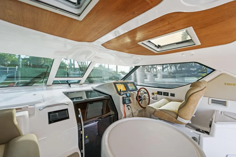 Slide: The Image of Interior of 2008 Tiara Yachts 4300 Sovran, featuring helm station and luxurious seating. - 24