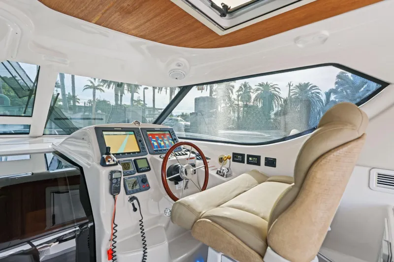 Slide: The Image of 2008 Tiara Yachts 4300 Sovran helm with modern controls and luxurious seating. - 25