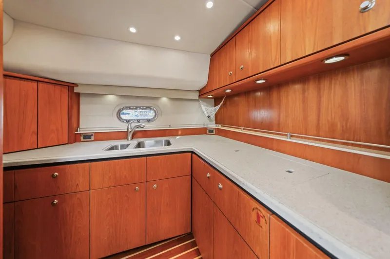 Slide: The Image of Luxurious 2008 Tiara Yachts 4300 Sovran kitchen with wood cabinetry and modern fixtures. - 28