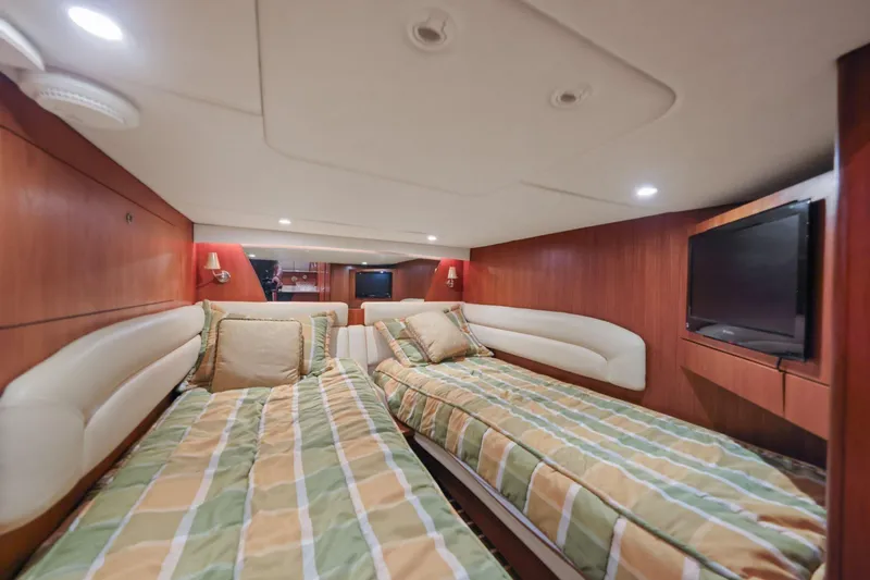 Slide: The Image of Luxurious 2008 Tiara Yachts 4300 Sovran cabin with twin beds and modern amenities. - 36