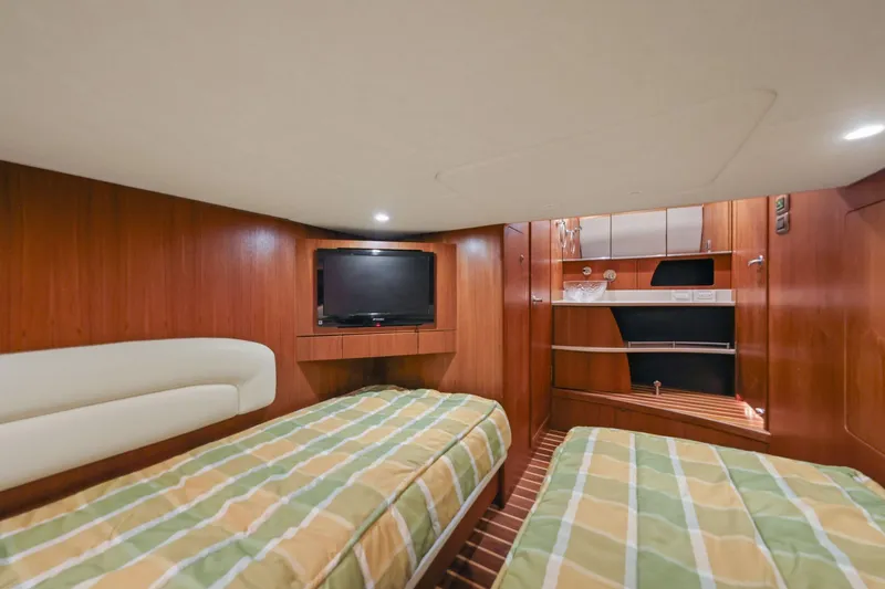 Slide: The Image of Luxurious 2008 Tiara Yachts 4300 Sovran cabin with twin beds and TV. - 37