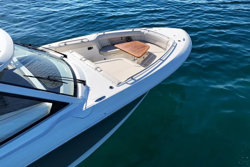 Slide: The Image of 2022 Boston Whaler 380 Realm boat on calm blue water, featuring a sleek design. - 12