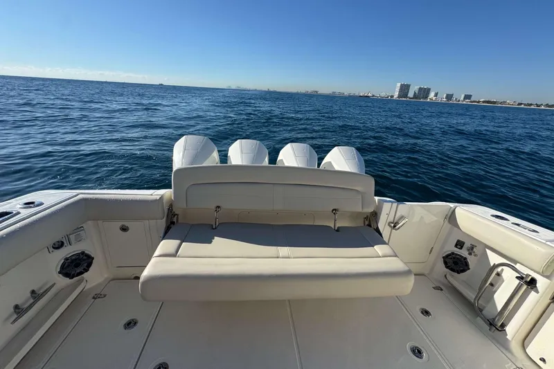 Slide: The Image of 2022 Boston Whaler 380 Realm boat with seating, ocean view, and city skyline. - 15