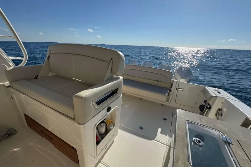 Slide: The Image of 2022 Boston Whaler 380 Realm boat interior with ocean view and seating area. - 19