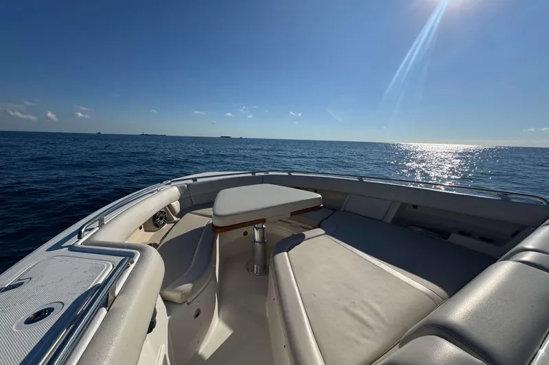 Slide: The Image of 2022 Boston Whaler 380 Realm boat interior with ocean view under clear blue sky. - 23