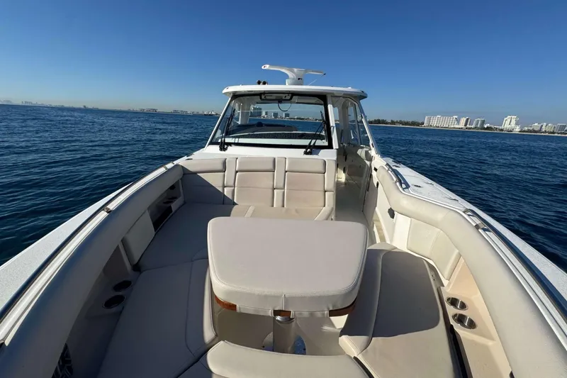 Slide: The Image of 2022 Boston Whaler 380 Realm boat on open water, featuring spacious seating and clear skies. - 25