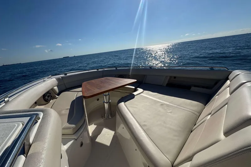 Slide: The Image of 2022 Boston Whaler 380 Realm boat interior with ocean view and seating area. - 28