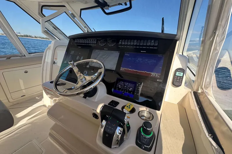 Slide: The Image of 2022 Boston Whaler 380 Realm helm with advanced navigation displays and controls. - 33