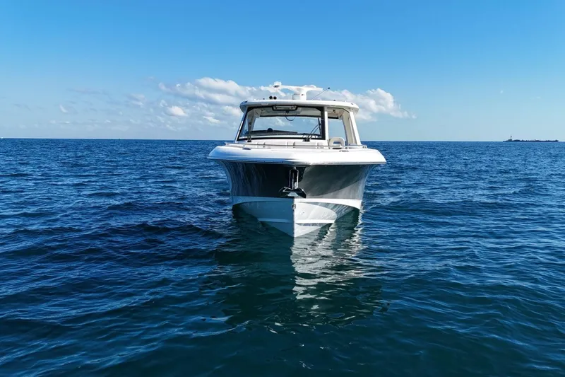 Slide: The Image of 2022 Boston Whaler 380 Realm boat on open sea under clear blue sky. - 8