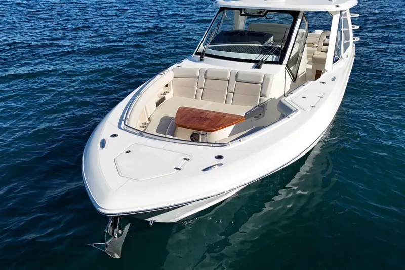 Slide: The Image of 2022 Boston Whaler 380 Realm boat on calm blue water. - 9