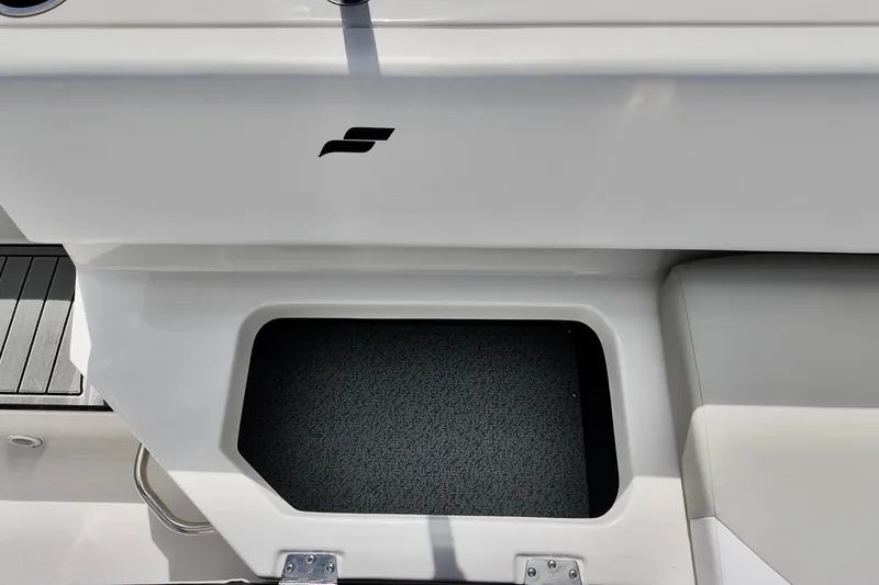 Slide: The Image of Starcraft SVX 171 OB 2026 boat storage compartment with sleek design and logo. - 11