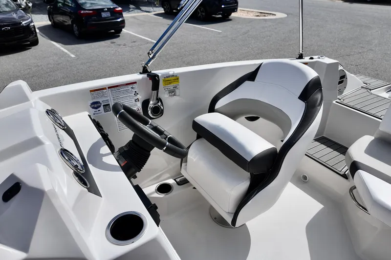 Slide: The Image of 2026 Starcraft SVX 171 OB boat interior with steering wheel and captain's chair. - 13