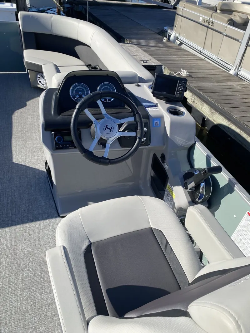 Slide: The Image of 2025 Harris FloteBote HCX23 pontoon boat interior with steering wheel and dashboard. - 5