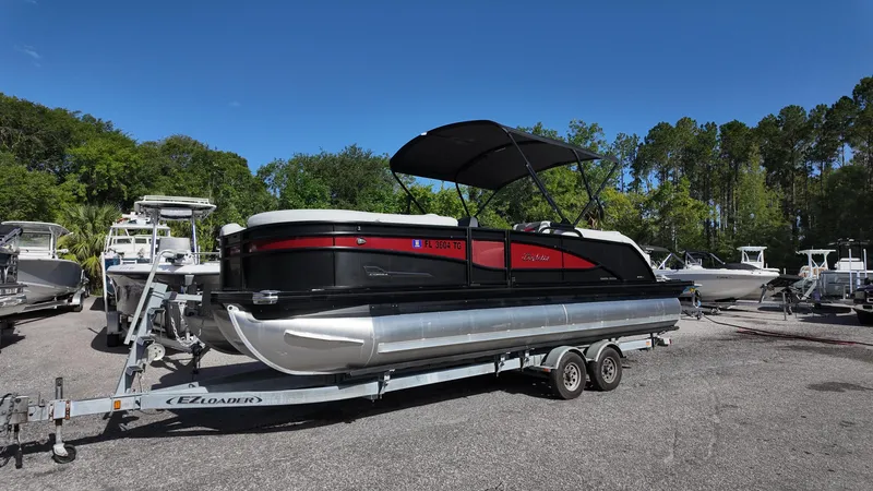 The Image of 2022 Barletta Corsa 23U pontoon boat on trailer, parked outdoors. - 0
