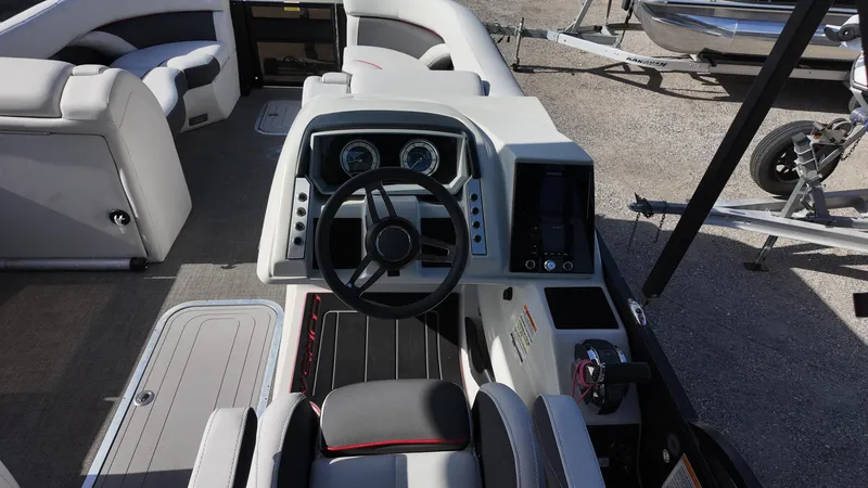 Slide: The Image of 2022 Barletta Corsa 23U boat interior with steering console and seating area. - 13
