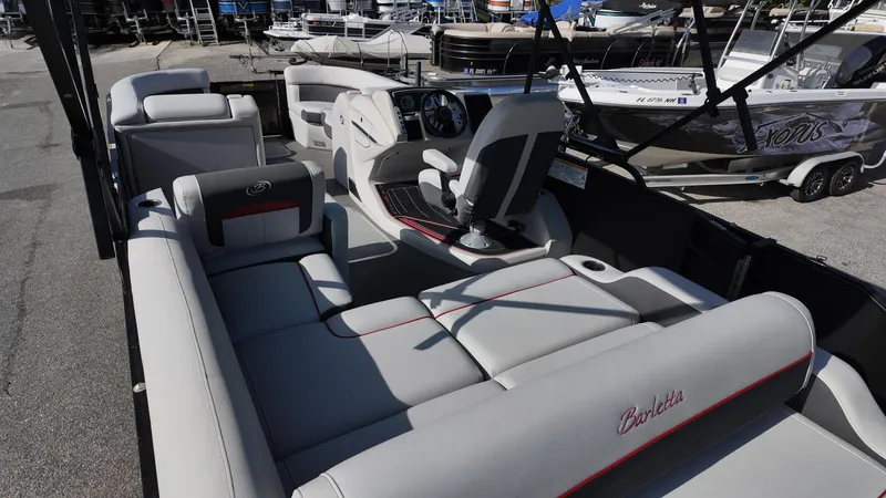 Slide: The Image of 2022 Barletta Corsa 23U pontoon boat interior with luxurious seating and modern dashboard. - 15
