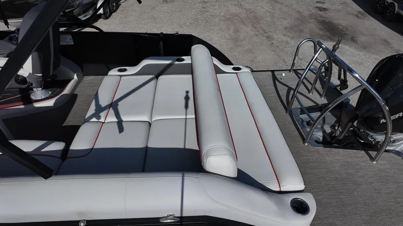 Slide: The Image of 2022 Barletta Corsa 23U boat interior with white seating and red accents. - 16