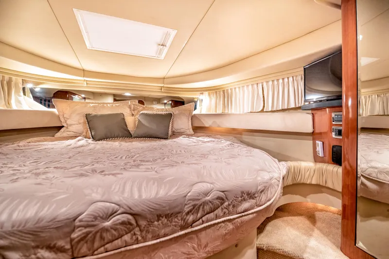 Slide: The Image of Luxurious cabin interior of 2002 Sea Ray 380 Sundancer yacht with cozy bedding and TV. - 10