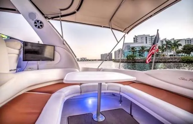 Slide: The Image of Interior view of 2002 Sea Ray 380 Sundancer yacht with seating and table. - 15