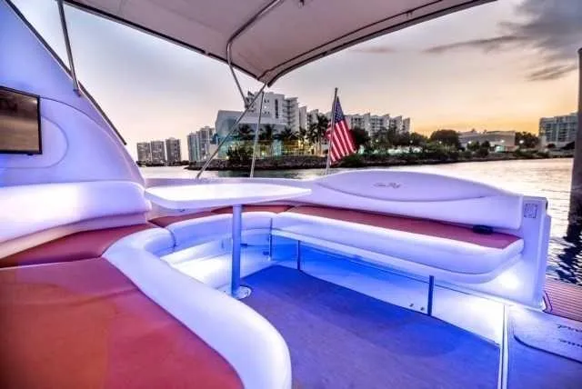 Slide: The Image of Luxurious 2002 Sea Ray 380 Sundancer yacht with spacious seating and scenic waterfront view. - 16