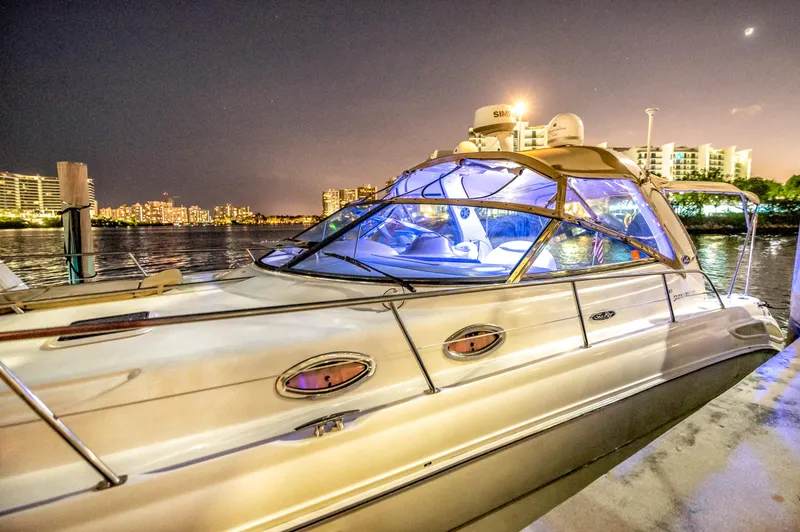 Slide: The Image of 2002 Sea Ray 380 Sundancer yacht docked at night with city lights. - 3