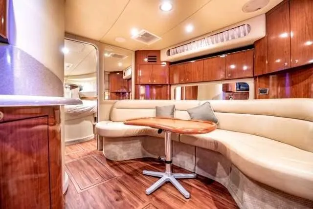Slide: The Image of Luxurious interior of 2002 Sea Ray 380 Sundancer yacht with plush seating and wooden finishes. - 7