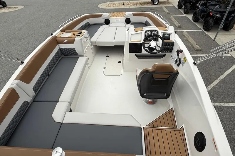 Slide: The Image of 2026 Starcraft SVX 191 OB boat interior with modern seating and steering console. - 12
