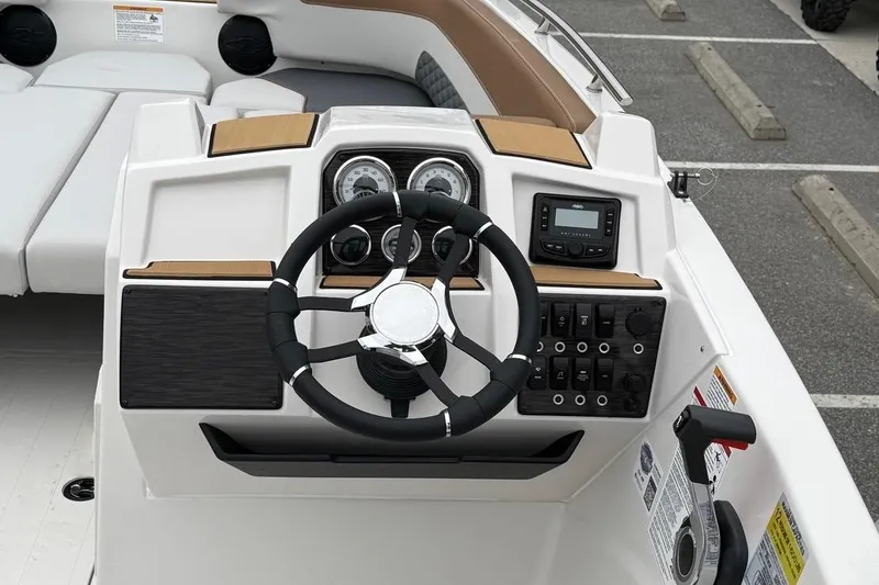 Slide: The Image of 2026 Starcraft SVX 191 OB boat dashboard with steering wheel and control panel. - 13
