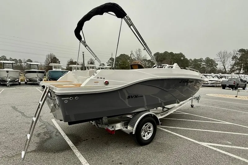 Slide: The Image of 2026 Starcraft SVX 191 OB boat on trailer in parking lot, overcast sky. - 4