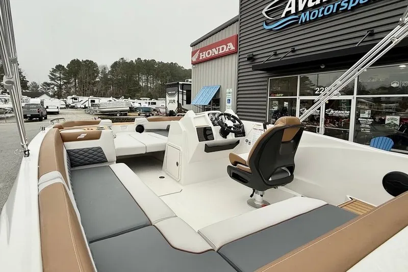 Slide: The Image of 2026 Starcraft SVX 191 OB boat interior at dealership, featuring spacious seating and modern design. - 9