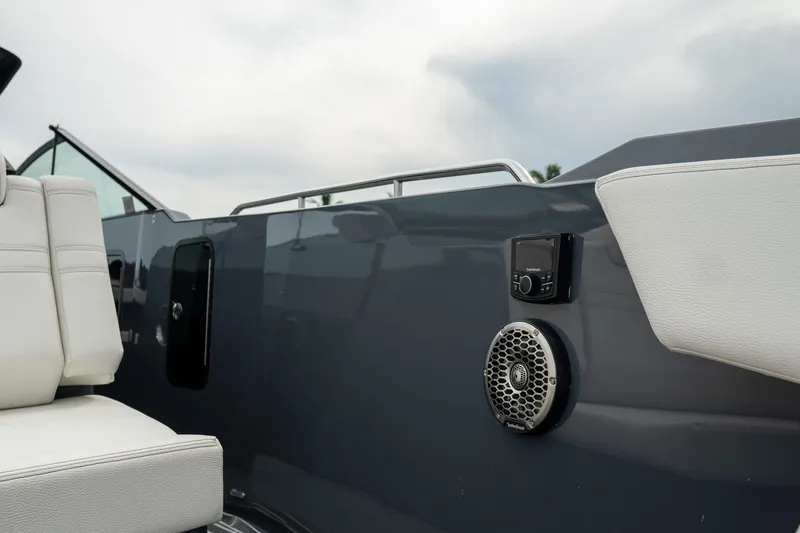 Slide: The Image of 2022 Cruisers Yachts 38 GLS interior with white seating and audio system, showcasing luxury design. - 16