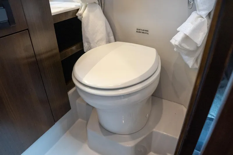 Slide: The Image of Luxury bathroom in 2022 Cruisers Yachts 38 GLS, featuring modern toilet design. - 39