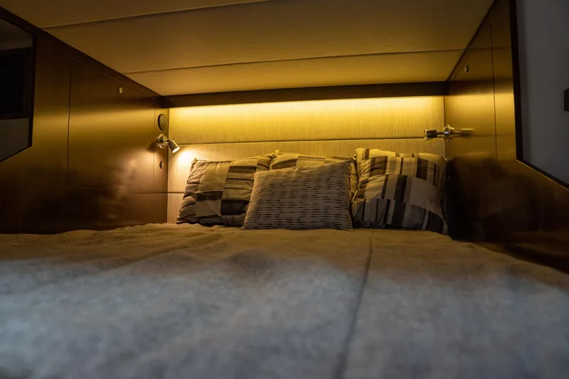 Slide: The Image of 2022 Cruisers Yachts 38 GLS cabin interior with cozy bed and ambient lighting. - 41