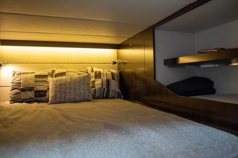 Slide: The Image of 2022 Cruisers Yachts 38 GLS cabin interior with cozy bedding and ambient lighting. - 42