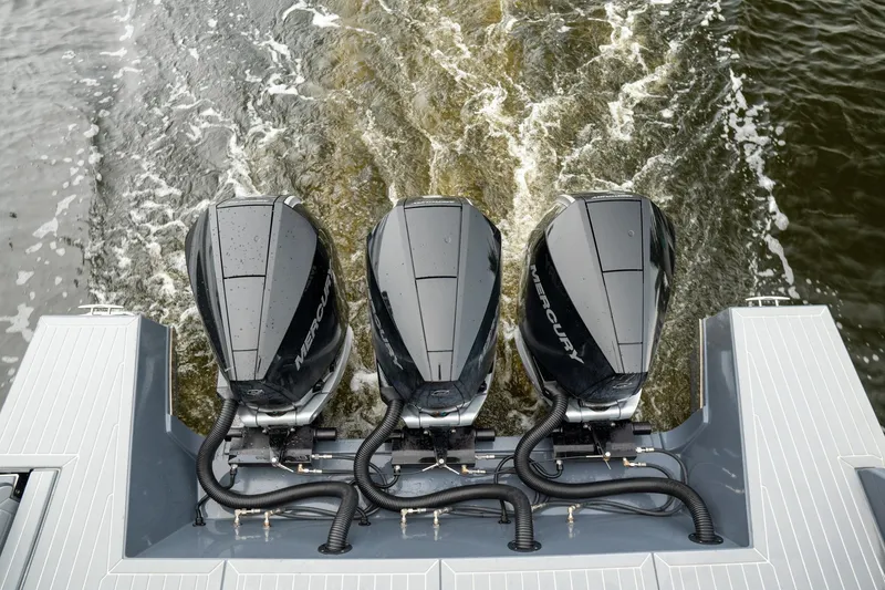 Slide: The Image of Triple Mercury outboard engines on 2022 Cruisers Yachts 38 GLS, cruising through water. - 45