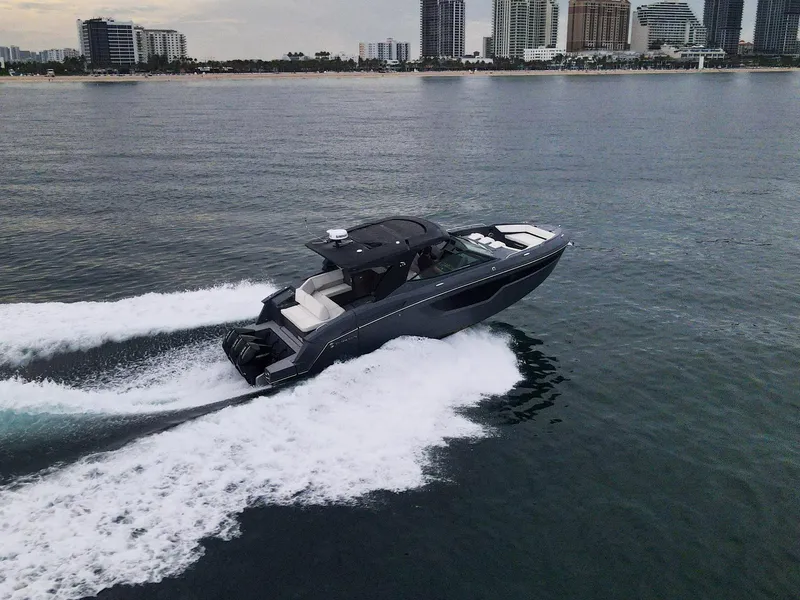 Slide: The Image of 2022 Cruisers Yachts 38 GLS speeding on water near city skyline. - 6