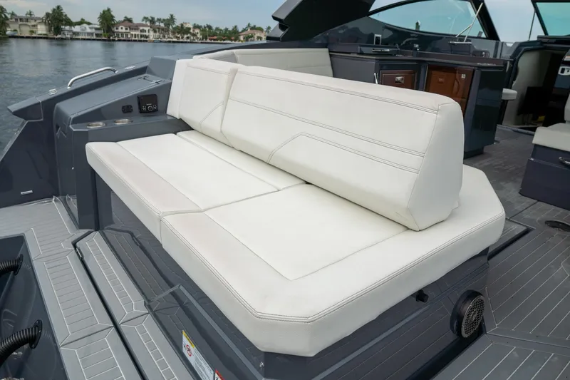 Slide: The Image of 2022 Cruisers Yachts 38 GLS interior with white seating, docked by the water. - 12