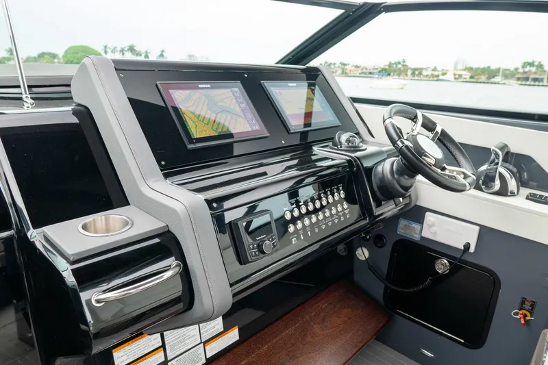 Slide: The Image of 2022 Cruisers Yachts 38 GLS helm with dual displays and modern controls. - 22