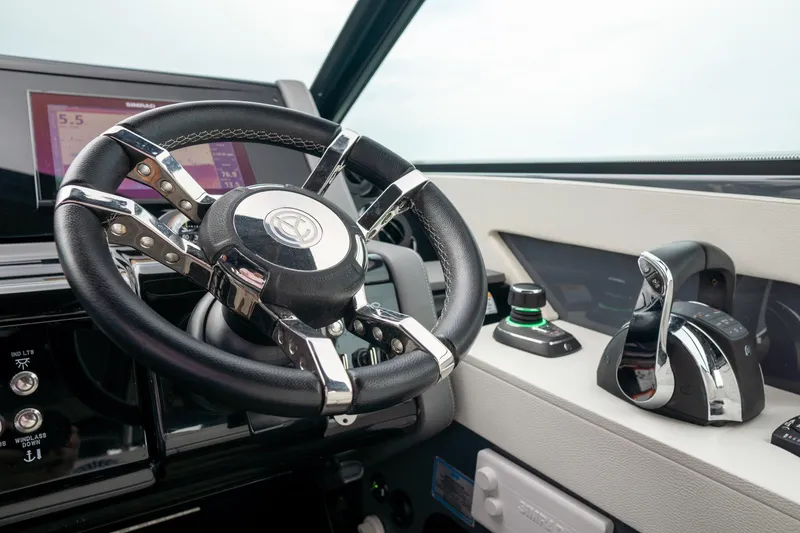 Slide: The Image of 2022 Cruisers Yachts 38 GLS helm with steering wheel and controls. - 23