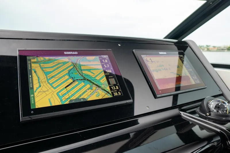 Slide: The Image of 2022 Cruisers Yachts 38 GLS dashboard with navigation screens and compass. - 26