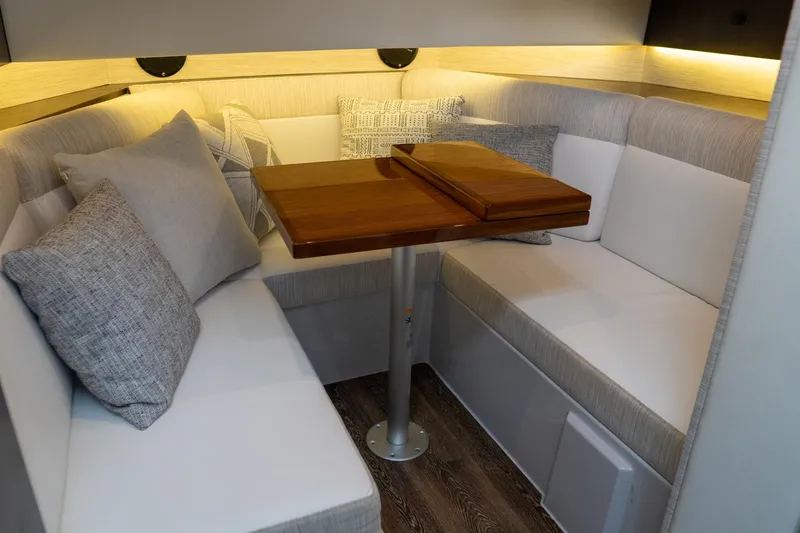 Slide: The Image of 2022 Cruisers Yachts 38 GLS interior with cozy seating and wooden table. - 37