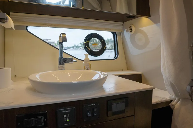 Slide: The Image of 2022 Cruisers Yachts 38 GLS bathroom with modern sink and window view. - 38