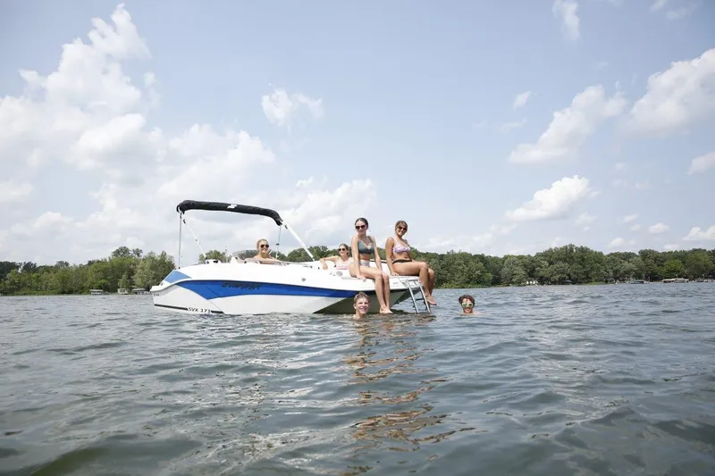 The Image of People enjoying a day on a 2026 Starcraft SVX 211 OB boat in a scenic lake. - 1