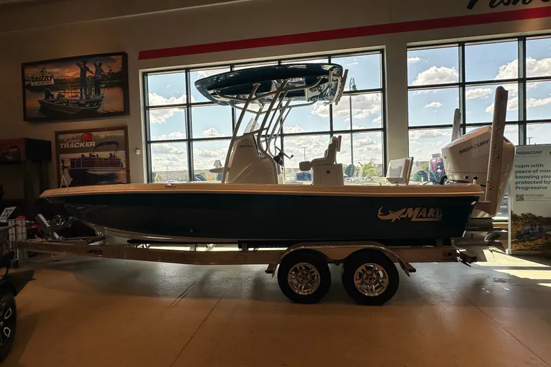 The Image of 2026 Mako 24 APEX boat displayed indoors on a trailer. - 0