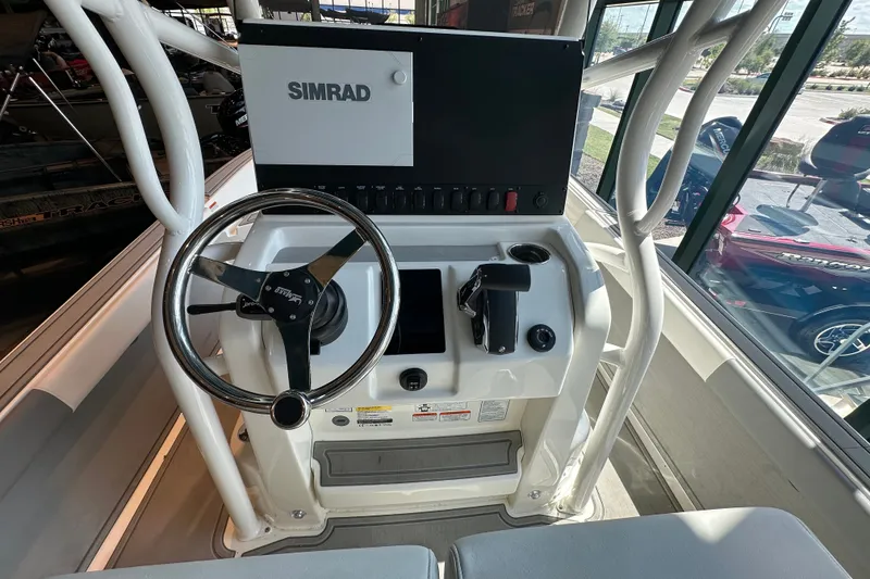 Slide: The Image of Steering console of 2026 Mako 24 APEX boat with Simrad navigation system. - 10