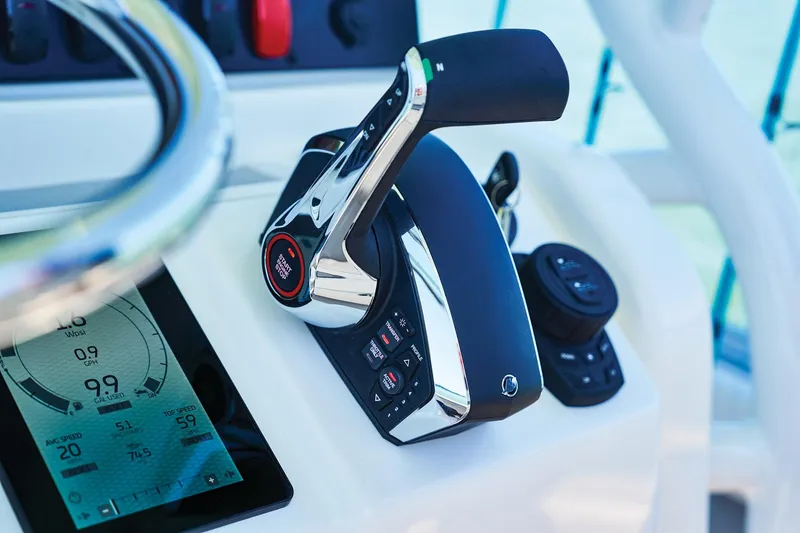 Slide: The Image of Close-up of 2026 Mako 24 APEX boat controls and digital display. - 64