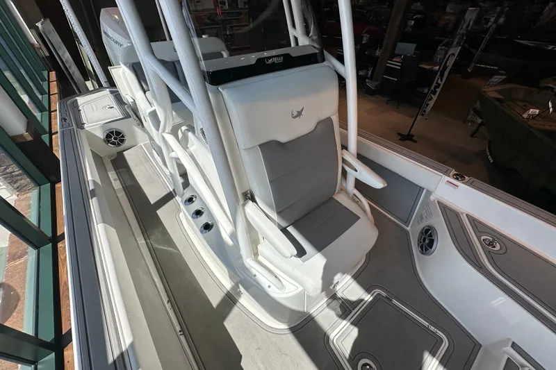 Slide: The Image of 2026 Mako 24 APEX boat interior with sleek seating and modern design features. - 13