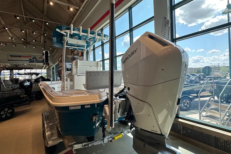 Slide: The Image of 2026 Mako 24 APEX boat with Mercury engine displayed in showroom. - 4