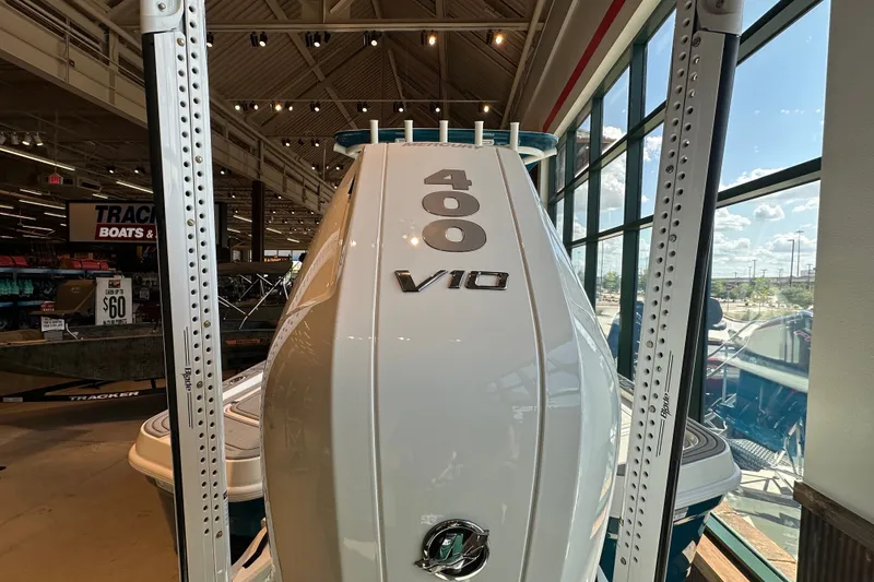 Slide: The Image of 2026 Mako 24 APEX boat with 400 V10 engine displayed indoors. - 5