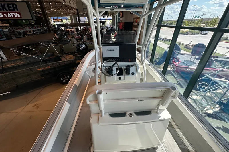 Slide: The Image of 2026 Mako 24 APEX boat interior with steering console in showroom. - 8